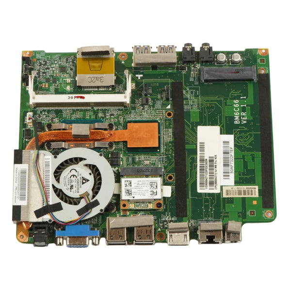 A green computer motherboard with various electronic components, a cooling fan, copper heat pipes, and multiple ports, photographed from above on a white background.